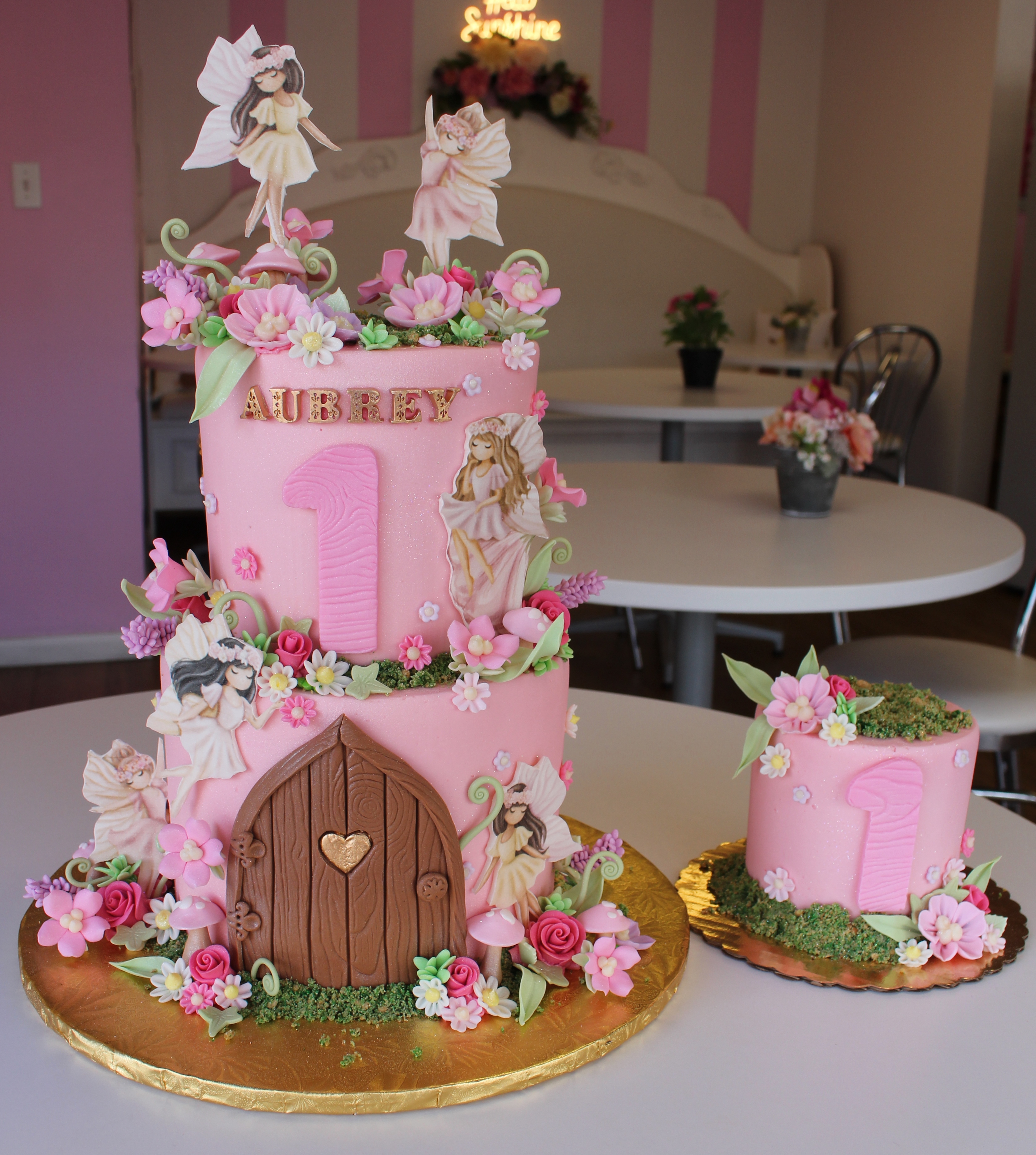 Pink Enchanted Woodland Forest Fairy Theme Girls First Birthday Cake with Fondant Fairies Flowers and Wooden Door