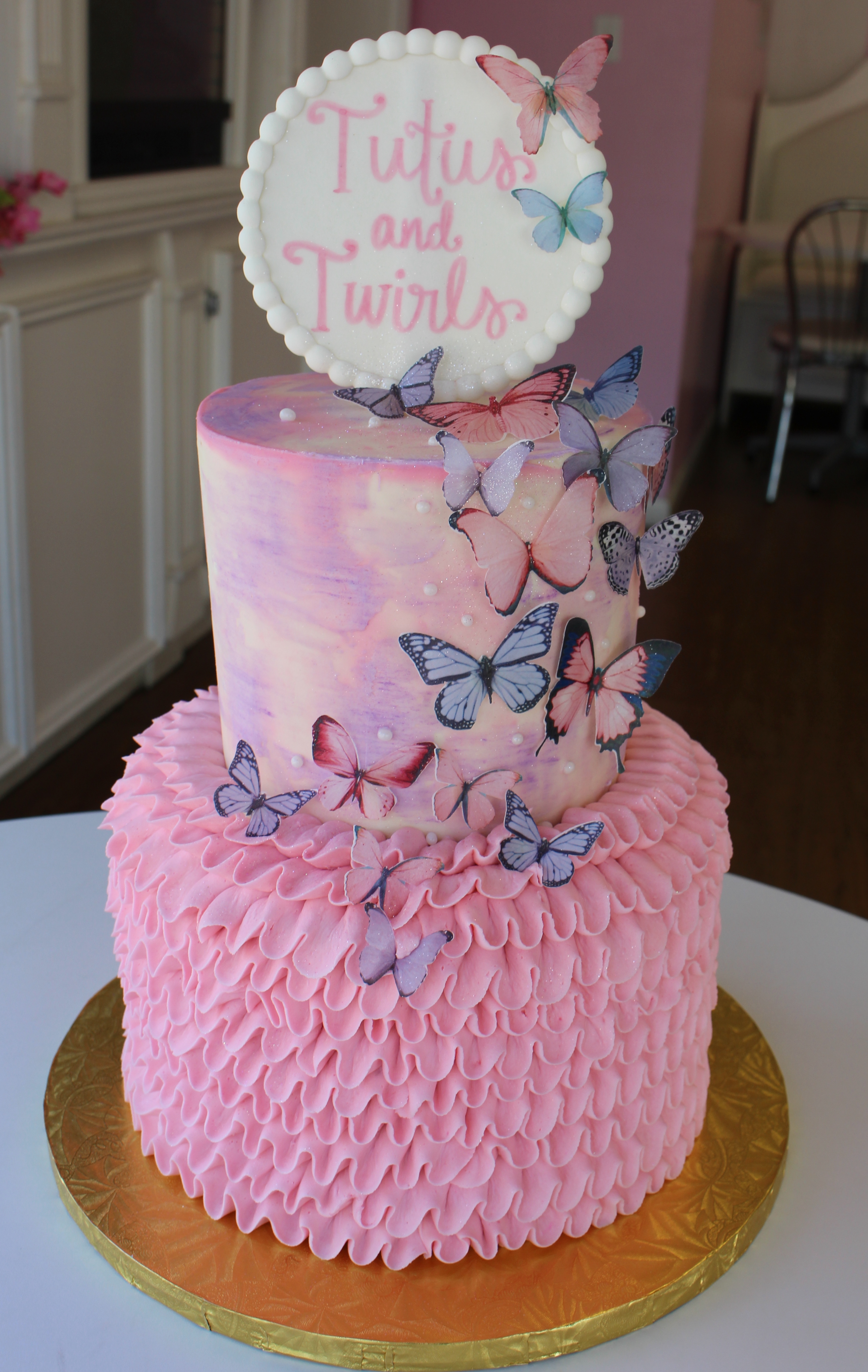 Pink and Purple 'Tutus and Twirls' Girls Birthday Cake with Watercolor Buttercream and Ruffled Tutu